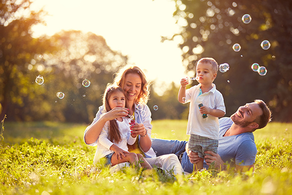 Family blowing bubbles
