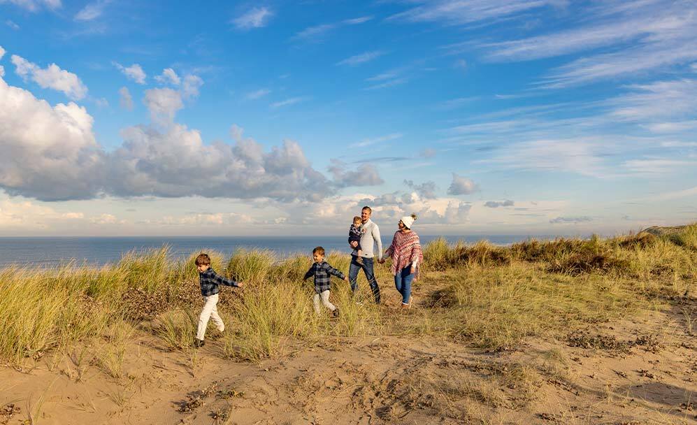 Gezin maakt strandwandeling